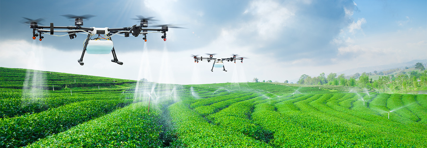 Drones flying over agricultural landscape