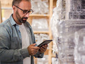 Man using tablet to check retail inventory 