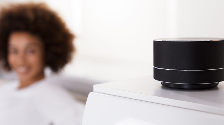 Close-up Of Black Wireless Speaker On Furniture