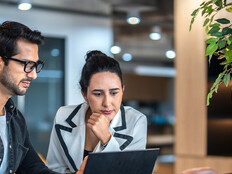 Coworkers reviewing computer